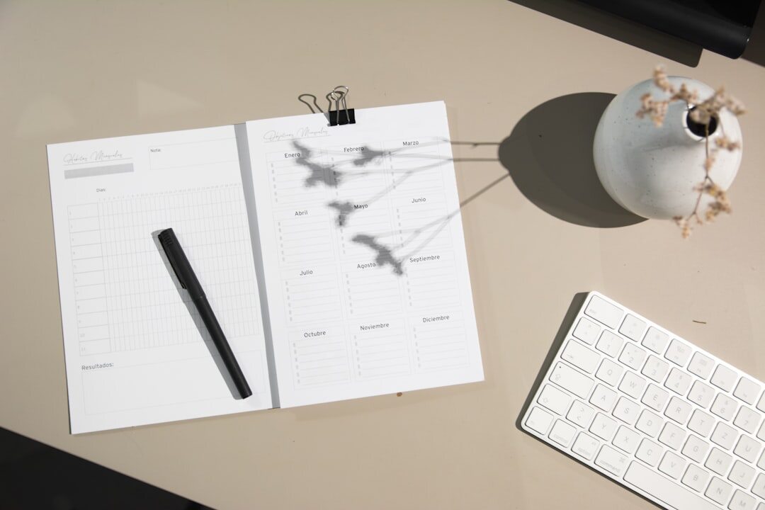 Notebook with pen and coffee cup on a desk