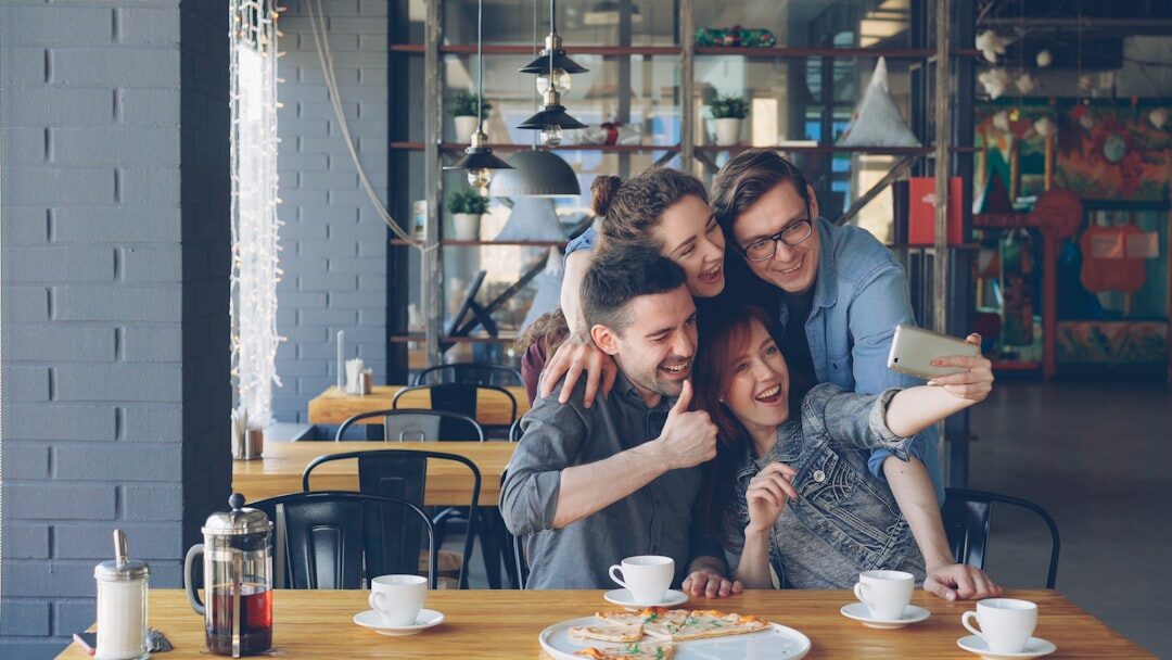 friends hugging in cafe