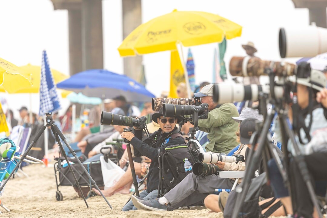Photographers with cameras and flashes at a press event